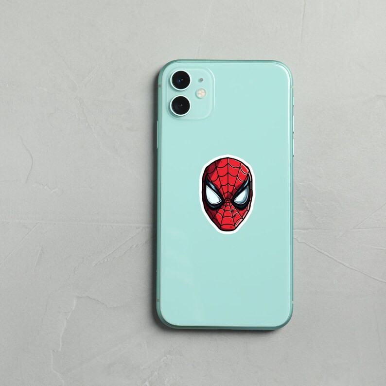 May include: A light blue smartphone case with a red and black Spider-Man sticker on the back.