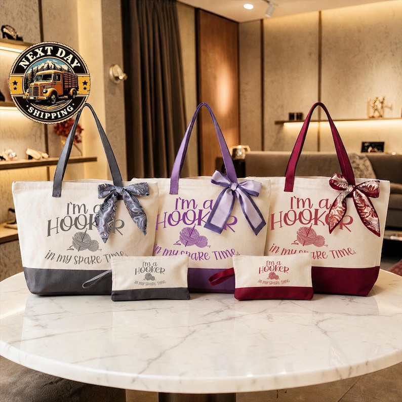 a collection of tote bags and a small bag, all featuring the text "I'm a Hooker" printed on them. The tote bags are arranged on a white marble table, with a couch and a lamp visible in the background.