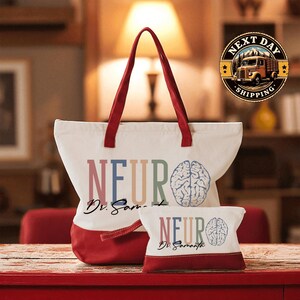 A large white tote bag with a red handle, featuring the text "NEURO" and "Dr. Sam" printed on it, along with a smaller tote bag with the same design. The bags are placed on a red surface, possibly a table or countertop.