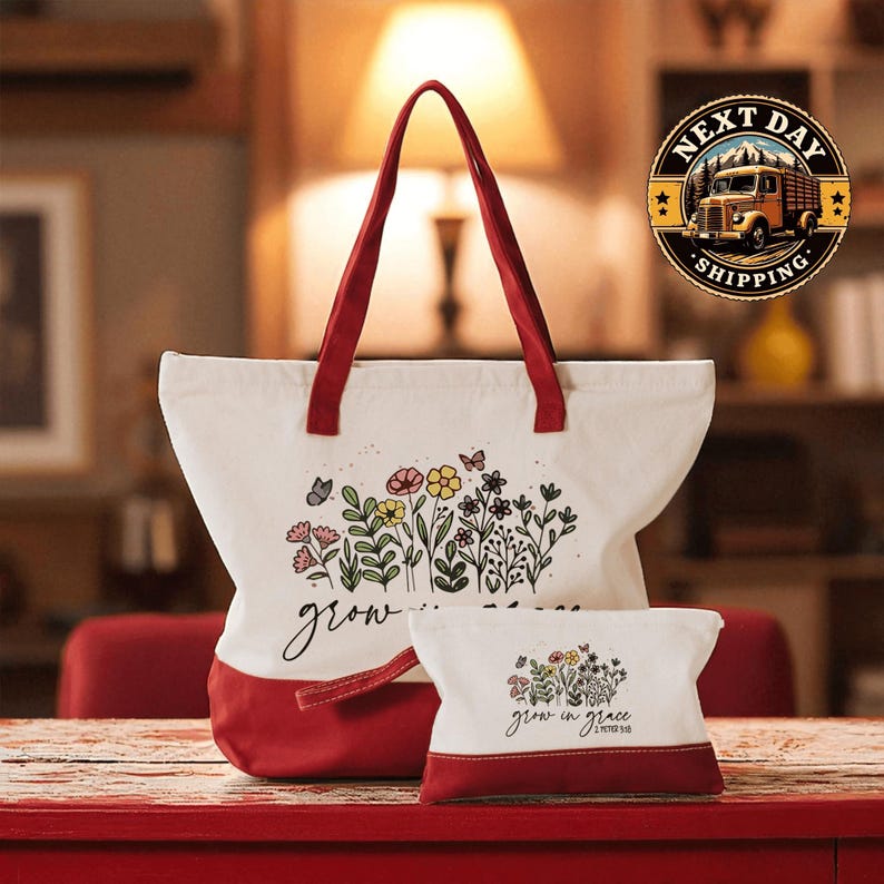 A large white tote bag with a red handle and a smaller white bag with a red handle, both featuring floral designs, are placed on a red surface.