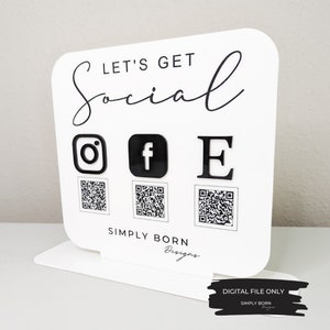 May include: White sign with black text that says "Let's Get Social" with Instagram, Facebook, and Email icons and QR codes below. The sign also says "Simply Born Designs" at the bottom.