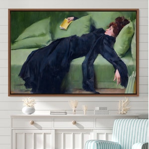 May include: A painting of a woman in a black dress lying on a green couch. She is holding a yellow book in her hand.