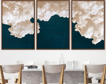 May include: Three framed prints of abstract art featuring a white cloud formation against a dark teal background.