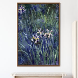 May include: A framed painting of purple irises with yellow centers, painted in a loose, impressionistic style. The flowers are surrounded by green and blue brushstrokes, creating a sense of depth and movement.