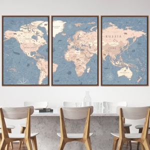 May include: A set of three framed world maps with a vintage style. The maps are printed on a light blue background with brown outlines and feature continent names in brown text. The maps are framed in a light brown wood frame.