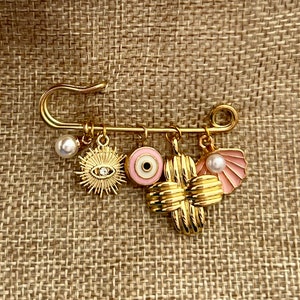 Filaxto Protection Charm Pin – Gold Baby Brooch with Evil Eye & Charms | Baptism Gift | Stroller Pin | Baby Shower Keepsake