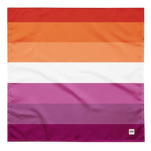 Op de afbeelding: Een rechthoekige vlag met het ontwerp van de lesbische pride-vlag. De vlag heeft horizontale strepen in tinten rood, oranje, wit, roze en paars. De vlag is gemaakt van stof en heeft een logo in de rechter benedenhoek.