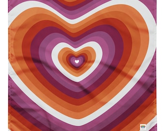 May include: A square fabric print with a large heart design. The heart is made up of concentric circles in shades of orange, pink, and white. The heart is centered on the fabric and fills most of the space.