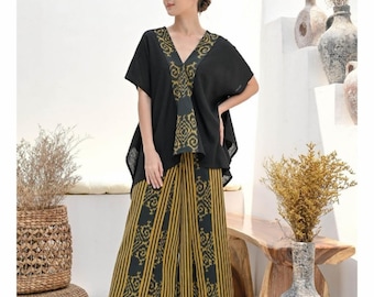 May include: A black and gold patterned top with a V-neck and short sleeves, paired with black and gold patterned pants.