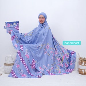 May include: A light blue prayer shawl with a floral pattern in shades of pink, purple, and gold. The shawl is made of a soft, silky fabric and comes with a matching pouch.