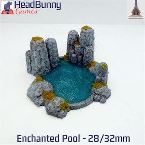 May include: A miniature 3D printed model of a rocky pool with a turquoise blue water surface. The pool is surrounded by gray rock formations with green moss and brown foliage. The model is 28/32mm in size.  Enchanted Pool - 28/32mm