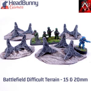 Peut inclure: Ensemble de terrain de champ de bataille miniature avec des obstacles gris et épineux et des figurines de soldats. L'ensemble comprend plusieurs pièces de terrain et figurines de soldats, parfait pour les jeux de table. Le texte en bas indique "Battlefield Difficult Terrain - 15 & 20mm."