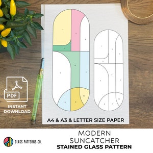 May include: A digital download pattern for a stained glass suncatcher. The pattern features a modern design with geometric shapes in yellow, pink, green, and blue. The pattern is available in A4, A3, and letter size paper.