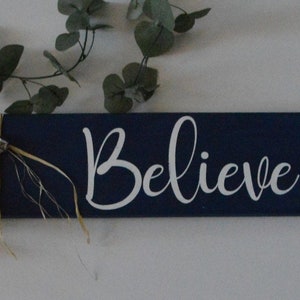 Believe wooden farmhouse sign with raffia and bells
