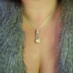 2.3 carat Ethiopian Fire Opal wire wrapped in luxurious 940 Argentium Silver, known for its superior brightness and tarnish resistance, into a high-end gemstone pendant necklace that exudes a whimsical earthy charm reminiscent of vintage treasures.