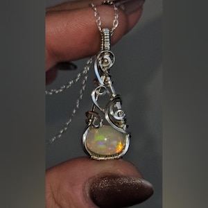 Stunning Ethiopian Fire Opal wire wrapped in 940 Argentium silver into a Vintage style pendant necklace, with a swirly, feminine, whimsical design.