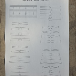 May include: A white sheet of paper labelled "Ring Shank Round Template 5" featuring ring shank designs and a table of measurements. The table includes template length, UK size, AU/NZ size, and inside diameter measurements. The designs are for jewelry making.