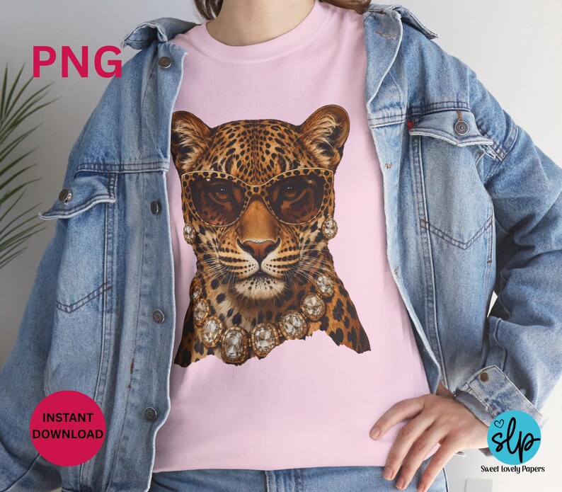 May include: Pink t-shirt featuring a leopard wearing sunglasses and a diamond necklace. The leopard has a spotted coat and is wearing brown-tinted sunglasses. The shirt also has the text "PNG" and "INSTANT DOWNLOAD".