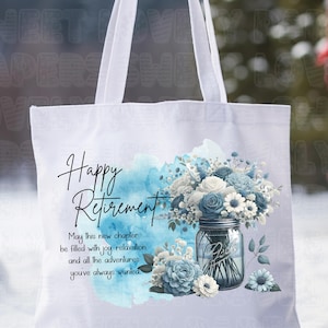 May include: White tote bag with a blue watercolor background and a mason jar filled with blue and white flowers. The text "Happy Retirement" is written in black cursive script. The text "May this new chapter be filled with joy relaxation and all the adventures you've always wanted." is written in black below the flowers.