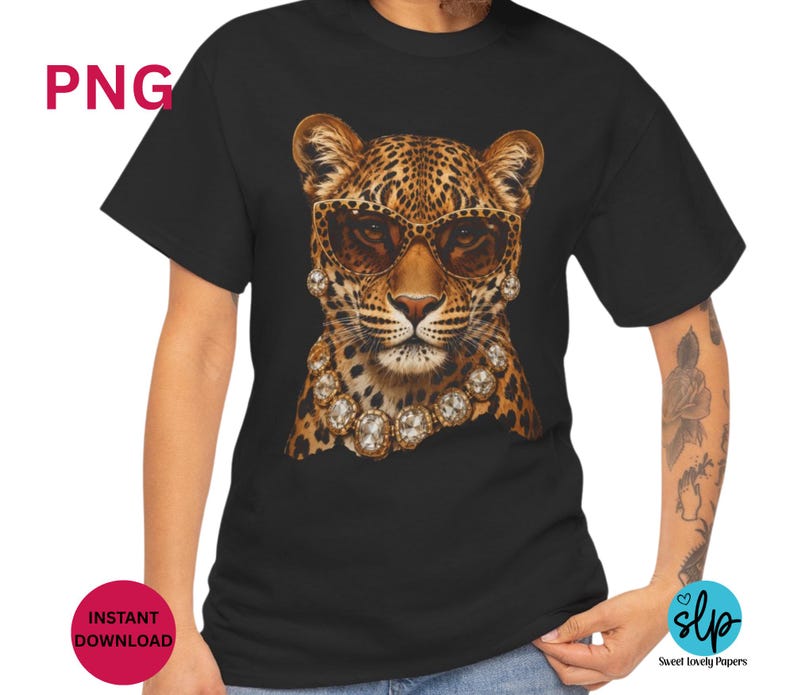 May include: Black t-shirt featuring a leopard wearing sunglasses and a diamond necklace. The leopard has a spotted pattern in shades of brown and tan. The sunglasses are brown. The shirt is a crew neck style.