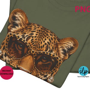 May include: Olive green t-shirt featuring a leopard's face wearing gold-rimmed sunglasses and jeweled earrings. The leopard has a spotted pattern. The image includes the text "PNG" and "Instant Download".