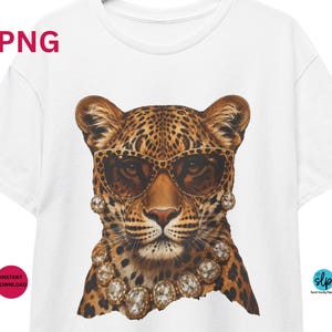 May include: White t-shirt featuring a leopard wearing sunglasses and a diamond necklace. The leopard has a spotted coat and is centered on the shirt. The text "PNG" is in the upper left corner, and "Instant Download" is in the lower left corner.
