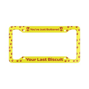 May include: Yellow license plate frame with red paw prints and the text "You've Just Buttered" and "Your Last Biscuit". The frame has a rectangular shape with rounded corners.