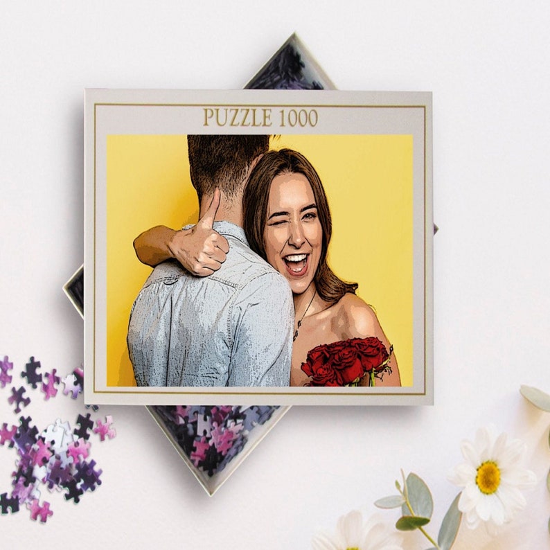 May include: A 1000 piece jigsaw puzzle featuring a couple embracing. The woman is smiling and holding a bouquet of red roses. The background is a bright yellow.