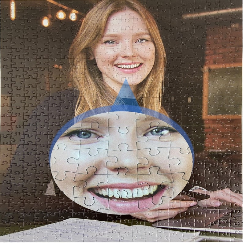May include: A close-up of a woman's face, with a magnifying glass over her mouth and teeth. The image is a jigsaw puzzle.