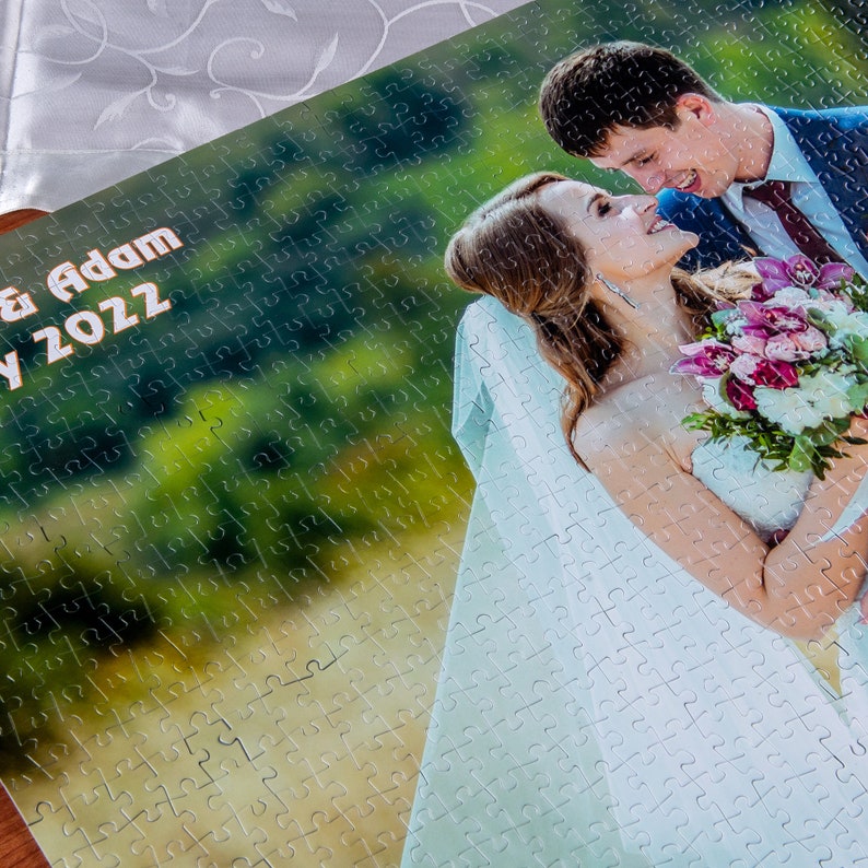 May include: A wedding jigsaw puzzle with a photo of a bride and groom kissing. The puzzle is personalized with the text "& Adam" and "July 2022".