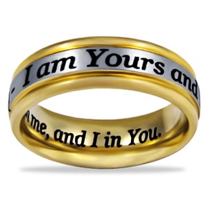 May include: A gold and silver ring with the inscription "I am Yours and You are Mine, and I in You."