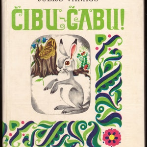 May include: A book cover with a green, blue, and white illustration of a rabbit sitting on a tree stump. The title of the book is "CIBUL-CABUI!" in green letters. The author's name, "JŪLIJS VANAGS", is printed in black letters above the title.