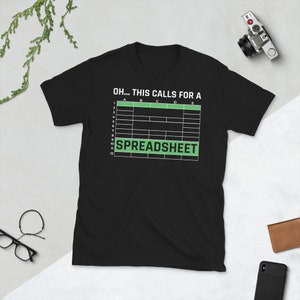May include: Black t-shirt with a green spreadsheet graphic and the text "OH... THIS CALLS FOR A SPREADSHEET".