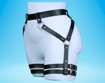 May include: Black leather harness with adjustable straps and buckles. The harness has a wide waistband and thigh straps.