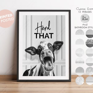 May include: Black and white photo of a cow with its mouth open, looking surprised. The text "Herd That" is above the cow. The image is framed in a black frame.