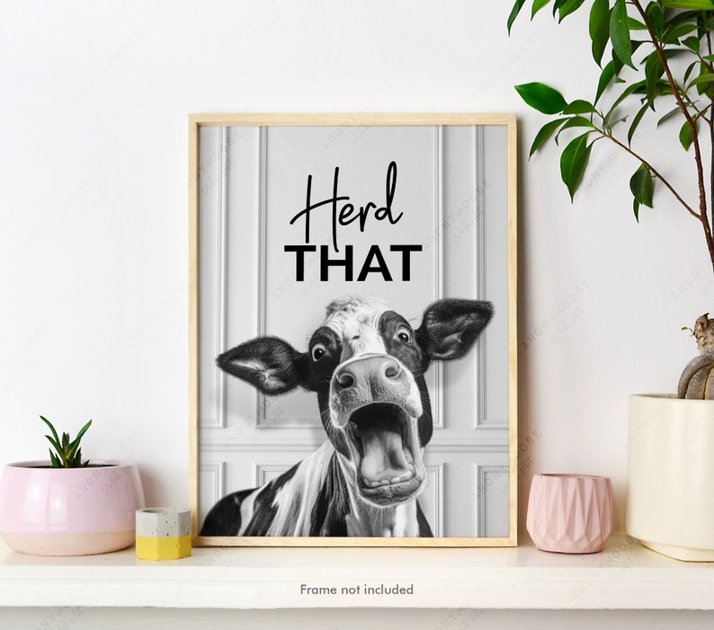 May include: Black and white photo of a cow with its mouth open, looking surprised. The text "Heard THAT" is above the cow. The photo is framed in a light wood frame.