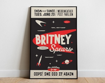 May include: A framed poster with a black background features the name "Britney Spears" in large red and white text. The poster includes the text "Show and Dance" and "Oops! She Did It Again," along with other details about a concert.