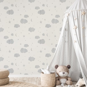 May include: A white canopy tent with a white and gray star pattern, a brown teddy bear, and a gray and white cloud and star patterned wallpaper.