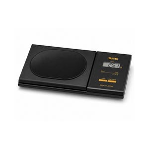 May include: A black digital kitchen scale with a round weighing surface and a digital display. The display shows a weight of 25.1 g. The scale has buttons for power and tare functions. The brand name "TANITA" is visible.