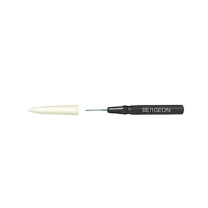 May include: A black watchmaker's tool with a white plastic tip and the word "BERGEON" printed on the handle.
