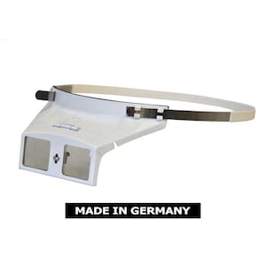 May include: White headband magnifier with two lenses and a metal band. The headband is adjustable and the lenses are clear. The magnifier is made in Germany.