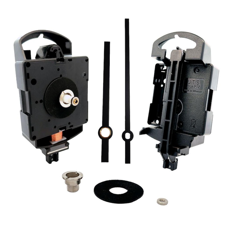 May include: A black clock movement kit with a quartz clock mechanism, two black clock hands, a black washer, a silver nut, and a silver screw. The clock movement has a white label that reads "J.U.T.S QUARTZ MADE IN GERMANY".