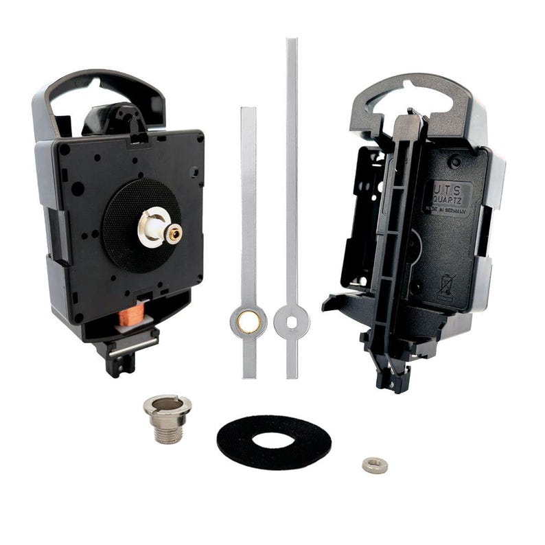 May include: A black clock movement kit with silver hands, a black washer, a silver nut, and a silver screw. The clock movement has a black plastic housing and a white label that reads "JITS QUARTZ MADE IN NORWAY".