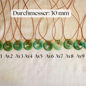 May include: Ten green jade donut pendants on brown cords. Each pendant is approximately 30 mm in diameter. The pendants are labeled Av1 through Av10. The text "Durchmesser: 30 mm" is displayed above the pendants.