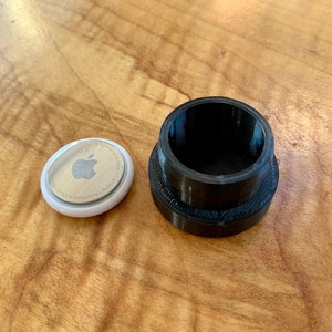AirTag next to mount for size comparison