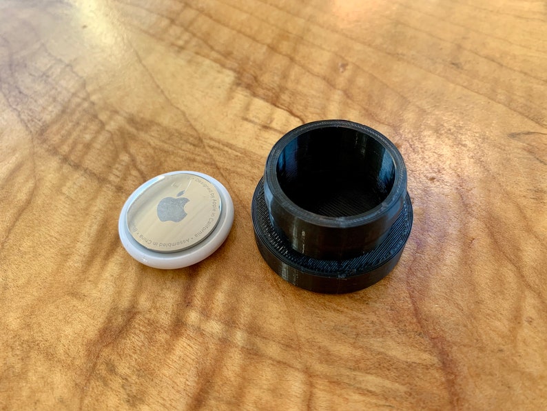AirTag next to mount for size comparison
