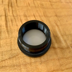 AirTag is squeezed inside the flexiable mount. Install it so the silver logo is facing inside and down.