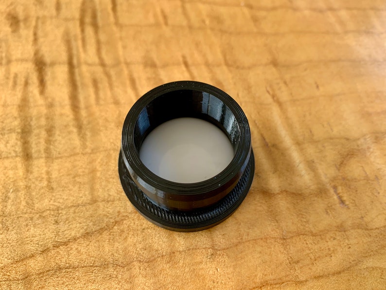 AirTag is squeezed inside the flexiable mount. Install it so the silver logo is facing inside and down.