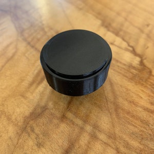 Underside of two part design that shows the cap installed.
