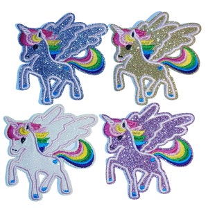 May include: Four glitter iron-on patches featuring a unicorn with wings and a rainbow tail. The unicorns are in blue, gold, white, and purple.